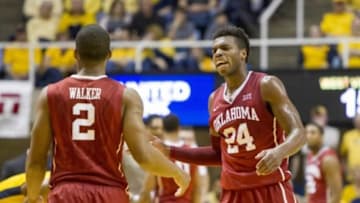 Feb 20, 2016; Morgantown, WV, USA; Oklahoma Sooners guard Buddy Hield (24) talks to guard Dinjiyl Walker (2) during the first half against the West Virginia Mountaineers at the WVU Coliseum. Mandatory Credit: Ben Queen-USA TODAY Sports