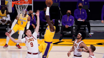 Mar 26, 2021; Los Angeles, California, USA; Los Angeles Lakers center Montrezl Harrell (15) flies to the basket between Cleveland Cavaliers guard Dylan Windler (9), center Jarrett Allen (31) and forward Dean Wade (32) during the first quarter at Staples Center. Mandatory Credit: Robert Hanashiro-USA TODAY Sports