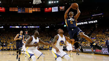 OAKLAND, CA - MAY 04: Rodney Hood #5 of the Utah Jazz drives against Andre Iguodala #9 and Draymond Green #23 of the Golden State Warriors during Game Two of the NBA Western Conference Semi-Finals at ORACLE Arena on May 4, 2017 in Oakland, California. (Photo by Ezra Shaw/Getty Images)