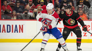 Dec 14, 2022; Ottawa, Ontario, CAN; Montreal Canadiens left wing Juraj Slafkovsky (20) moves the puck in front of Ottawa Senators center Shane Pinto (57) in the first period at the Canadian Tire Centre. Mandatory Credit: Marc DesRosiers-USA TODAY Sports