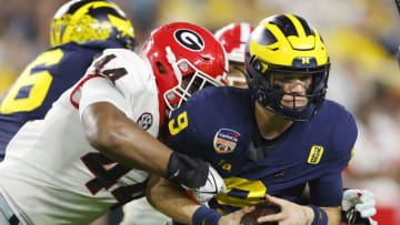 MIAMI GARDENS, FLORIDA - DECEMBER 31: Travon Walker #44 of the Georgia Bulldogs attempts to tackle J.J. McCarthy #9 of the Michigan Wolverines in the fourth quarter in the Capital One Orange Bowl for the College Football Playoff semifinal game at Hard Rock Stadium on December 31, 2021 in Miami Gardens, Florida. (Photo by Michael Reaves/Getty Images)