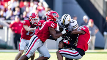 ATHENS, GA - OCTOBER 15: Jamon Dumas-Johnson #10 and Daylen Everette #6 of the Georgia Bulldogs combine for a tackle on Will Sheppard #14 of the Vanderbilt Commodores during a game between Vanderbilt Commodores and Georgia Bulldogs at Sanford Stadium on October 15, 2022 in Athens, Georgia. (Photo by Steve Limentani/ISI Photos/Getty Images)