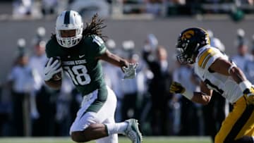 EAST LANSING, MI - SEPTEMBER 30: Wide receiver Felton Davis III #18 of the Michigan State Spartans is pursued by defensive back Amani Hooker #27 of the Iowa Hawkeyes during the first half at Spartan Stadium on September 30, 2017 in East Lansing, Michigan. (Photo by Duane Burleson/Getty Images)