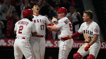 Jul 2, 2021; Anaheim, California, USA; Los Angeles Angels designated hitter Shohei Ohtani (17) celebrates with coaches and teammates after scoring the winning run in the ninth inning against the Baltimore Orioles at Angel Stadium. Mandatory Credit: Robert Hanashiro-USA TODAY Sports