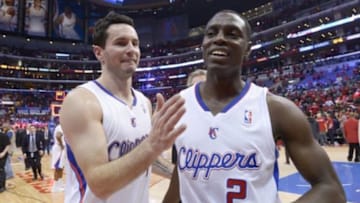 May 3, 2014; Los Angeles, CA, USA; Los Angeles Clippers guards J.J. Redick (4) and Darren Collison (2) embrace at the end of game seven of the first round of the 2014 NBA Playoffs against the Golden State Warriors at Staples Center. The Clippers defeated the Warriors 126-121 to win the series 4-3. Mandatory Credit: Kirby Lee-USA TODAY Sports