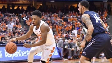 Dec 3, 2016; Syracuse, NY, USA; Syracuse Orange guard John Gillon (4) drives the ball past North Florida Ospreys guard Dallas Moore (14) during the second half of a game at the Carrier Dome. Syracuse won 77-71. Mandatory Credit: Mark Konezny-USA TODAY Sports