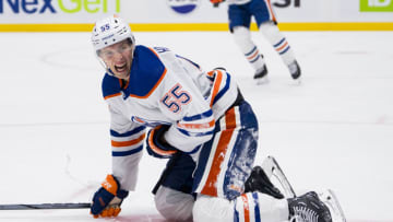 Oct 11, 2023; Vancouver, British Columbia, CAN; Edmonton Oilers forward Dylan Holloway (55) reacts after getting hit by a puck against the Vancouver Canucks in the third period at Rogers Arena. Vancouver won 8-1. Mandatory Credit: Bob Frid-USA TODAY Sports