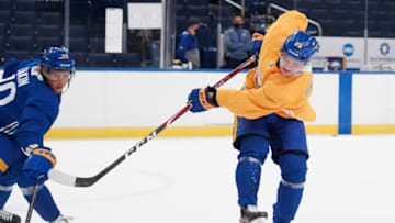 BUFFALO, NY - JANUARY 1: Arttu Ruotsalainen #25 takes a shot as Cody Eakin #20 of the Buffalo Sabres defends during training camp at KeyBank Center on January 1, 2021 in Buffalo, New York. (Photo by Kevin Hoffman/Getty Images)