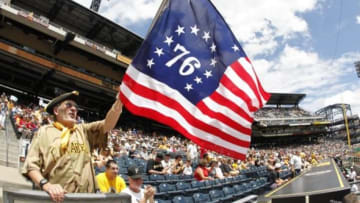 Jul 4, 2013; Pittsburgh, PA, USA; Pittsburgh Pirates fan Ed Sweeney waves a flag in honor of the July 4th holiday as the Pittsburgh Pirates host the Philadelphia Phillies before the game at PNC Park. Mandatory Credit: Charles LeClaire-USA TODAY Sports
