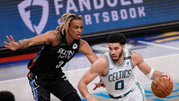 NEW YORK, NEW YORK - JUNE 01: Jayson Tatum #0 of the Boston Celtics dribbles as Nicolas Claxton #33 of the Brooklyn Nets defends during the first half of Game Five of their Eastern Conference first-round playoff series at Barclays Center on June 01, 2021 in the Brooklyn borough of New York City. NOTE TO USER: User expressly acknowledges and agrees that, by downloading and or using this photograph, User is consenting to the terms and conditions of the Getty Images License Agreement. (Photo by Sarah Stier/Getty Images)