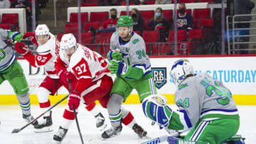 Apr 10, 2021; Raleigh, North Carolina, USA; Carolina Hurricanes defenseman Jaccob Slavin (74) and goaltender Petr Mrazek (34) defend against Detroit Red Wings left wing Evgeny Svechnikov (37) during the second period at PNC Arena. Mandatory Credit: James Guillory-USA TODAY Sports