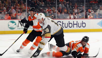 PHILADELPHIA, PENNSYLVANIA - OCTOBER 21: Robert Hagg #8 and Shayne Gostisbehere #53 of the Philadelphia Flyers defend against Reilly Smith #19 of the Vegas Golden Knights at the Wells Fargo Center on October 21, 2019 in Philadelphia, Pennsylvania. (Photo by Bruce Bennett/Getty Images)