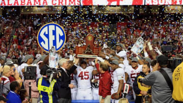 Dec 6, 2014; Atlanta, GA, USA; Alabama Crimson Tide head coach Nick Saban and his team celebrate with the trophy after the 2014 SEC Championship Game against the Missouri Tigers at the Georgia Dome. Alabama defeated Missouri 42-13. Mandatory Credit: Kevin Liles-USA TODAY Sports