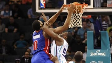 Apr 1, 2015; Charlotte, NC, USA; Detroit Pistons forward center Andre Drummond (0) drives to the basket and scores as he is fouled by Charlotte Hornets forward Jason Maxiell (53) during the second half of the game at Time Warner Cable Arena. Hornets won 102-78. Mandatory Credit: Sam Sharpe-USA TODAY Sports