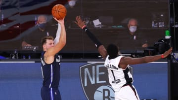 LAKE BUENA VISTA, FLORIDA - AUGUST 23: Luka Doncic #77 of the Dallas Mavericks hits a game winning three point basket against Reggie Jackson #1 of the LA Clippers during overtime in Game Four of the Western Conference First Round during the 2020 NBA Playoffs at AdventHealth Arena at ESPN Wide World Of Sports Complex on August 23, 2020 in Lake Buena Vista, Florida. NOTE TO USER: User expressly acknowledges and agrees that, by downloading and or using this photograph, User is consenting to the terms and conditions of the Getty Images License Agreement. (Photo by Kevin C. Cox/Getty Images)
