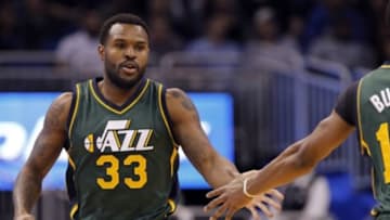 Dec 19, 2014; Orlando, FL, USA; Utah Jazz forward Trevor Booker (33) high fives guard Alec Burks (10) after he made a three pointer against the Orlando Magic during the first quarter at Amway Center. Mandatory Credit: Kim Klement-USA TODAY Sports
