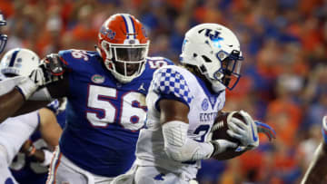 Sep 8, 2018; Gainesville, FL, USA; Kentucky Wildcats running back Benny Snell Jr. (26) runs with the ball as Florida Gators defensive lineman Tedarrell Slaton (56) defends at Ben Hill Griffin Stadium. Kentucky Wildcats defeated the Florida Gators 27-16. Mandatory Credit: Kim Klement-USA TODAY Sports