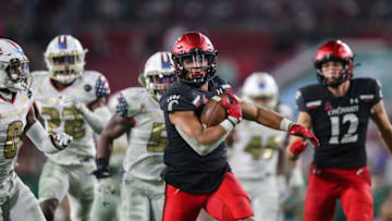 Ryan Montgomery runs the ball during game against the South Florida Bulls. The Enquirer.