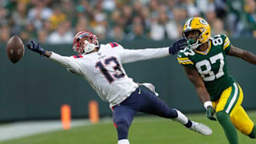 New England Patriots cornerback Jack Jones (13) tries to intercept an overthrown pass to Green Bay Packers wide receiver Romeo Doubs (87) during their football game Sunday, October 2, at Lambeau Field in Green Bay, Wis.Dan Powers/USA TODAY NETWORK-WisconsinApc Packvspatriots 1002221895djp