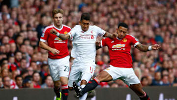 MANCHESTER, ENGLAND - SEPTEMBER 12: Roberto Firmino of Liverpool is challenged by Memphis Depay of Manchester United during the Barclays Premier League match between Manchester United and Liverpool at Old Trafford on September 12, 2015 in Manchester, United Kingdom. (Photo by Shaun Botterill/Getty Images)