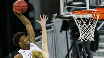 Jan 6, 2021; Columbia, South Carolina, USA; South Carolina Gamecocks forward Jalyn McCreary (4) dunks over Texas A&M Aggies guard Hayden Hefner (2) in the first half at Colonial Life Arena. Mandatory Credit: Jeff Blake-USA TODAY Sports