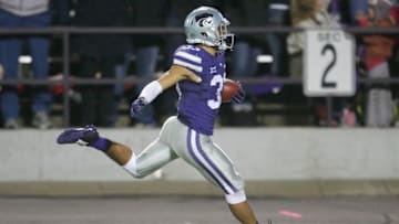 Dec 5, 2015; Manhattan, KS, USA; Kansas State Wildcats return specialist Morgan Burns (33) carries the ball for a 97-yard kick-off return touchdown against the West Virginia Mountaineers at Bill Snyder Family Football Stadium. The Wildcats won 24-23. Mandatory Credit: Scott Sewell-USA TODAY Sports