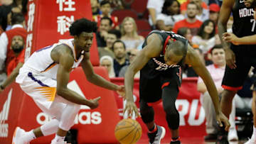 HOUSTON, TX - MARCH 30: Luc Mbah a Moute #12 of the Houston Rockets battles with Josh Jackson #20 of the Phoenix Suns for a loose ball in the second half at Toyota Center on March 30, 2018 in Houston, Texas. NOTE TO USER: User expressly acknowledges and agrees that, by downloading and or using this photograph, User is consenting to the terms and conditions of the Getty Images License Agreement. (Photo by Tim Warner/Getty Images)