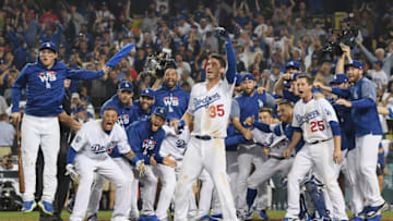 LOS ANGELES, CA - OCTOBER 26: The Los Angeles Dodgers await to congratulate Max Muncy #13 at home plate after his eighteenth inning walk-off home run to defeat the the Boston Red Sox 3-2 in Game Three of the 2018 World Series at Dodger Stadium on October 26, 2018 in Los Angeles, California. (Photo by Harry How/Getty Images)