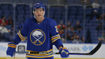 BUFFALO, NEW YORK - SEPTEMBER 27: Lawrence Pilut #20 of the Buffalo Sabres looks on during the third period against the Philadelphia Flyers at KeyBank Center on September 27, 2022 in Buffalo, New York. (Photo by Joshua Bessex/Getty Images)