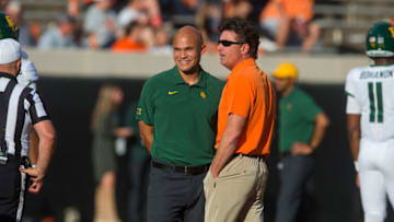 Oct 2, 2021; Stillwater, Oklahoma, USA; Oklahoma State Cowboys head coach Mike Gundy (right) talks with Baylor Bears head coach Dave Aranda before the game at Boone Pickens Stadium. Mandatory Credit: Brett Rojo-USA TODAY Sports