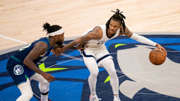 Memphis Grizzlies guard Ja Morant (12) dribbles against the Minnesota Timberwolves guard Patrick Beverley (22)(Brad Rempel-USA TODAY Sports)