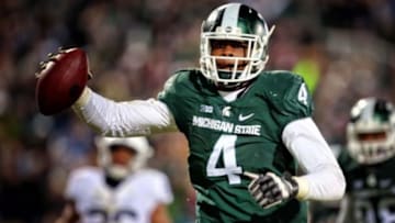 Nov 28, 2015; East Lansing, MI, USA; Michigan State Spartans defensive lineman Malik McDowell (4) scores a on an interception return during the second half of a game against the Penn State Nittany Lions at Spartan Stadium. Mandatory Credit: Mike Carter-USA TODAY Sports