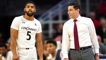Cincinnati Bearcats guard David DeJulius talks to head coach Wes Miller against New Jersey Tech Highlanders at Fifth Third Arena. The Enquirer.