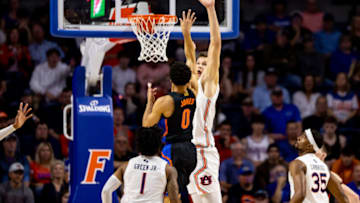 Feb 19, 2022; Gainesville, Florida, USA; Florida Gators guard Myreon Jones (0) shoots over Auburn Tigers forward Walker Kessler (13) during the first half at Billy Donovan Court at Exactech Arena. Mandatory Credit: Matt Pendleton-USA TODAY Sports
