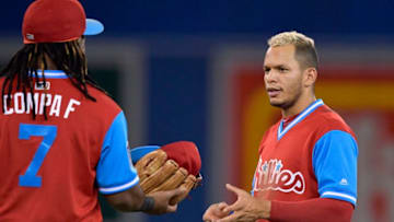TORONTO, ON - AUGUST 25: Philadelphia Phillies Infielder Cesar Hernandez (16 ) gets his glove delivered by teammate Third Baseman Maikel Franco (7) during an inning change in the MLB game between the Philadelphia Phillies and the Toronto Blue Jays at Rogers Centre in Toronto, ON., Canada August 25, 2018. The Jays won 8-6. (Photo by Jeff Chevrier/Icon Sportswire via Getty Images)