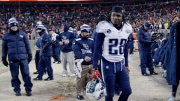 Dec 8, 2013; Denver, CO, USA; Tennessee Titans running back Chris Johnson (28) reacts on the sidelines late in the fourth quarter against the Denver Broncos at Sports Authority Field at Mile High. The Broncos defeated the Titans 51-28. Mandatory Credit: Ron Chenoy-USA TODAY Sports