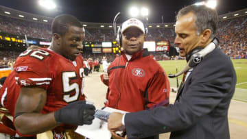 Head Coach Mike Nolan and Mike Singletary meet with Patrick Willis #52 of the San Francisco 49ers (Photo by Michael Zagaris/Getty Images)