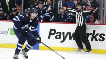 Dec 10, 2019; Winnipeg, Manitoba, CAN; Winnipeg Jets center Adam Lowry (17) skates up the ice against the Detroit Red Wings in the second period at Bell MTS Place. Mandatory Credit: James Carey Lauder-USA TODAY Sports