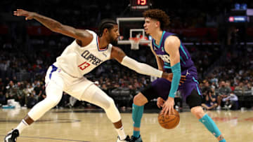 LOS ANGELES, CALIFORNIA - NOVEMBER 07: LaMelo Ball #2 of the Charlotte Hornets handles the ball against Paul George #13 of the Los Angeles Clippers during the third quarter at Staples Center on November 07, 2021 in Los Angeles, California. NOTE TO USER: User expressly acknowledges and agrees that, by downloading and or using this photograph, User is consenting to the terms and conditions of the Getty Images License Agreement. (Photo by Katelyn Mulcahy/Getty Images)