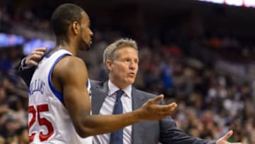Feb 21, 2014; Philadelphia, PA, USA; Philadelphia 76ers head coach Brett Brown talks with guard Elliot Williams (25) during the third quarter against the Dallas Mavericks at the Wells Fargo Center. The Mavericks defeated the Sixers 124-112. Mandatory Credit: Howard Smith-USA TODAY Sports