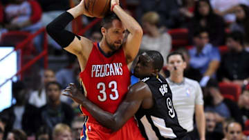 Feb 21, 2015; Miami, FL, USA; New Orleans Pelicans forward Ryan Anderson (33) holds the ball as Miami Heat forward Luol Deng (9) defends during the first half at American Airlines Arena. Mandatory Credit: Steve Mitchell-USA TODAY Sports