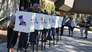 People vote at outdoor booths during early voting for the mid-term elections in Pasadena, California on November 3, 2018. (Photo by Mark RALSTON / AFP) (Photo credit should read MARK RALSTON/AFP/Getty Images)