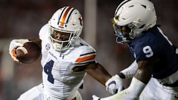 Auburn footballSTATE COLLEGE, PA - SEPTEMBER 18: Tank Bigsby #4 of the Auburn Tigers carries the ball as Joey Porter Jr. #9 of the Penn State Nittany Lions defends during the second half at Beaver Stadium on September 18, 2021 in State College, Pennsylvania. (Photo by Scott Taetsch/Getty Images)