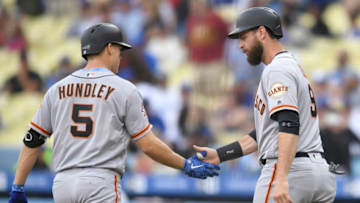 LOS ANGELES, CA - JUNE 17: Nick Hundley #5 of the San Francisco Giants is congratulated for his two run home run by Brandon Belt #9 in the first inning against the Los Angeles Dodgers at Dodger Stadium on June 17, 2018 in Los Angeles, California. (Photo by John McCoy/Getty Images)