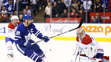 Carey Price #31 of the Montreal Canadiens makes a glove save on John Tavares #91 of the Toronto Maple Leafs in overtime during an NHL game at Scotiabank Arena. (Photo by Vaughn Ridley/Getty Images)