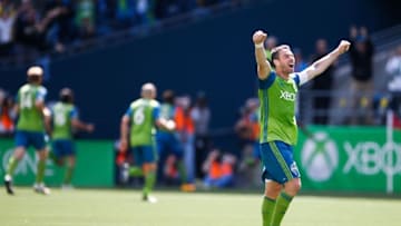 Apr 30, 2016; Seattle, WA, USA; Seattle Sounders defender Zach Scott (20) celebrates a goal by forward Jordan Morris (in background) during the second half against the Columbus Crew at CenturyLink Field. Seattle won 1-0. Mandatory Credit: Jennifer Buchanan-USA TODAY Sports