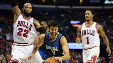 Oct 24, 2014; St. Louis, MO, USA; Minnesota Timberwolves guard Ricky Rubio (9) dribbles the ball as Chicago Bulls forward Taj Gibson (22) and guard Derrick Rose (1) defend during the first quarter at Scottrade Center. The Timberwolves won 113-112. Mandatory Credit: Jeff Curry-USA TODAY Sports