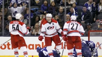 Jan 21, 2016; Toronto, Ontario, CAN; Carolina Hurricanes forward Jordan Staal (11) celebrates his overtime goal with defenseman Brett Pesce (54) and defenseman Justin Faulk (27) as Toronto Maple Leafs defenceman Morgan Rielly (44) and goaltender James Reimer (34) kneel on the ice at the Air Canada Centre. Carolina defeated Toronto 1-0 in overtime. Mandatory Credit: John E. Sokolowski-USA TODAY Sports
