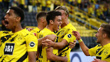 Borussia Dortmund players celebrate a goal (Photo by Dean Mouhtaropoulos/Getty Images)