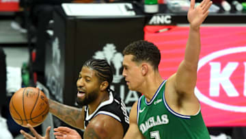 Dec 27, 2020; Los Angeles, California, USA; Los Angeles Clippers guard Paul George (left) drives against Dallas Mavericks center Dwight Powell (7) in the first quarter at Staples Center. Mandatory Credit: Jayne Kamin-Oncea-USA TODAY Sports